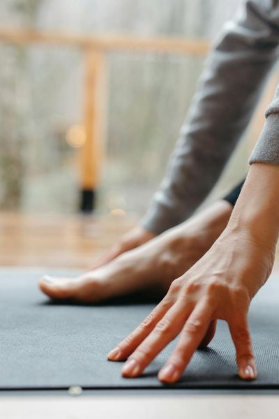 Close-up of bare feet on a textured exercise mat, suggesting focus and grounding.